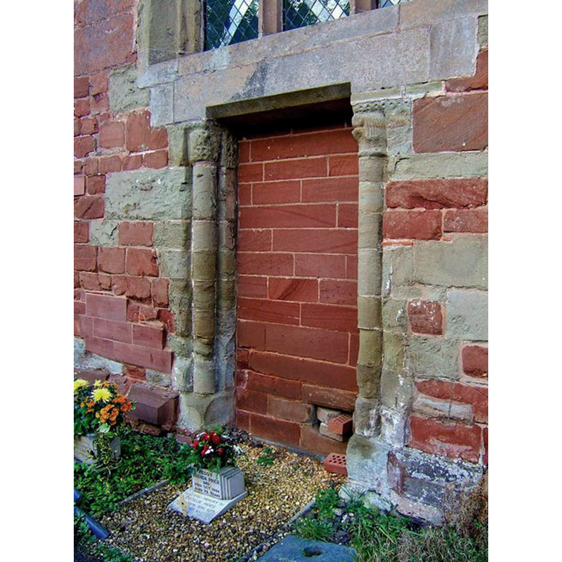 Source caption: "This doorway was blocked at the time the church was rebuilt in 1878/9. There was originally a porch here, but because it was in a ruinous state, it was removed when the door was blocked."
