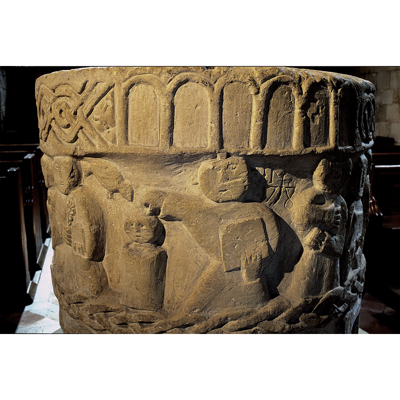 Baptism of Christ. Figure holding book in left hand, branch in right hand held across chest. On the left, a cylindrical font with a small child inside, showing head and neck. A bird from above descends. To the right of the font, full frontal holds a book in left hand and right hand extended toward the head of the figure in the font. A cruciform on head of standing figure -- on the east side of the font [NB: orientation is approximate]