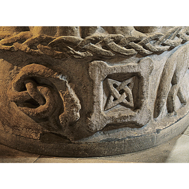 A serpent with double twist in tail. Situated to the left of triquetta symbol -- on the northeast side of the basin [NB: orientation is approximate]