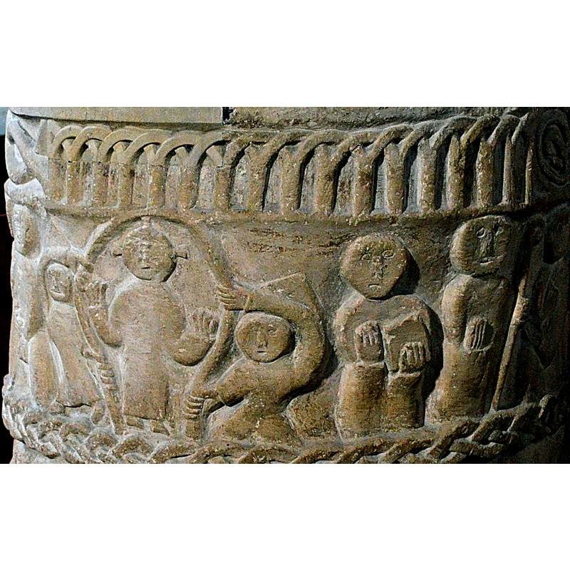 Christ in Majesty -or Ascension of Christ. Horseshoe mandorla, figure of Christ with cruciform on head. Hands raised in orant pose. Two angel hold the mandorla. To the right, figure holding book. A figure holding bishop's staff. To the right again, a figure holds his right elbow with left hand, right hand raised across his chest -- on the southwest side of the font [NB: orientation is approximate]