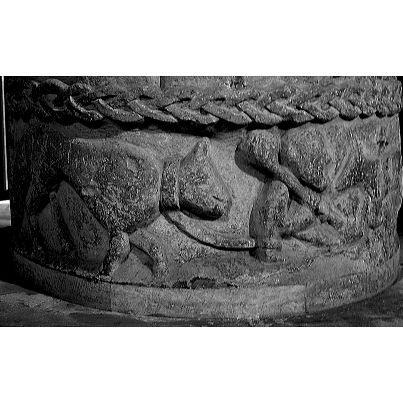 Lower Level: A large fox (?) being led by a leash by a man facing right and holding a club on his right shoulder -- on the north side of the basin [NB: orientation is approximate]