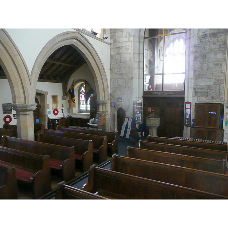 Source caption: "St. Michael and All Angels' church, Claverdon - interior. View from the pulpit towards the west end and ringing chamber at the base of the 15th century tower." -- the modern font and cover are visible by the tower arch
