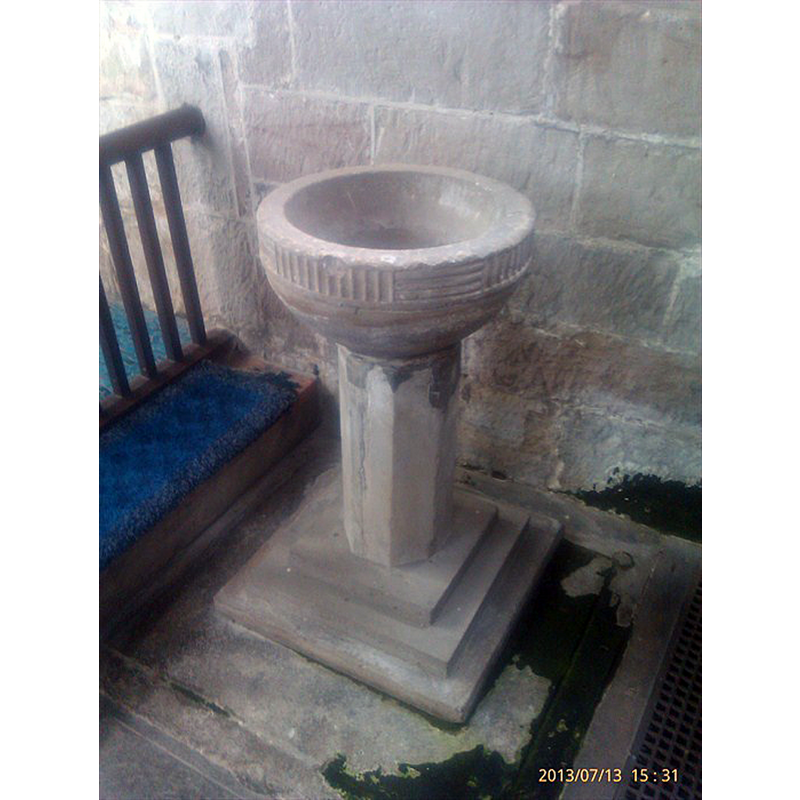 Source caption: "One of two baptism fonts inside the church"