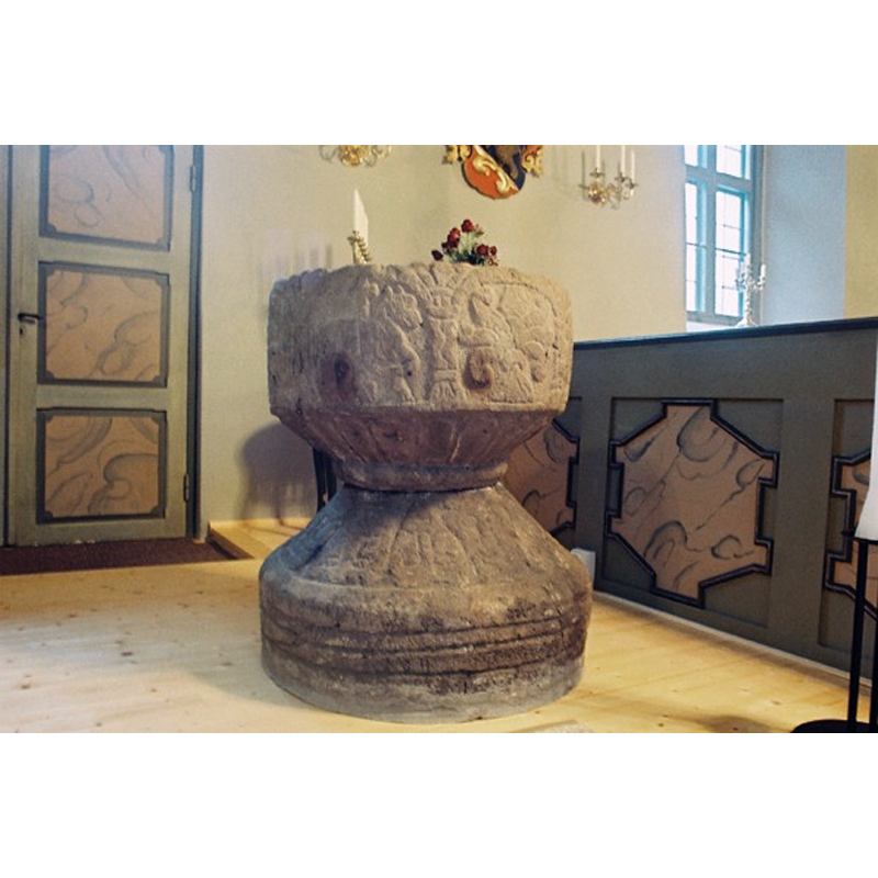 in 2003, the date of this photograph, the font was on the south side of the chancel