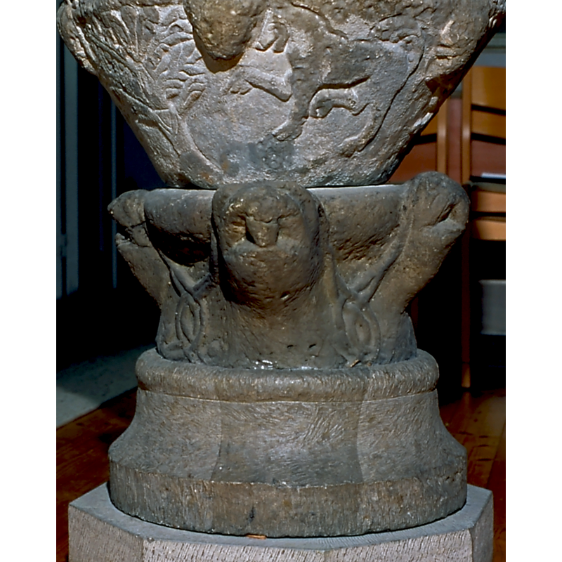 though much eroded now, it was probably rendered originally as an animal head -- on the east side of the base [orientation is approximate]