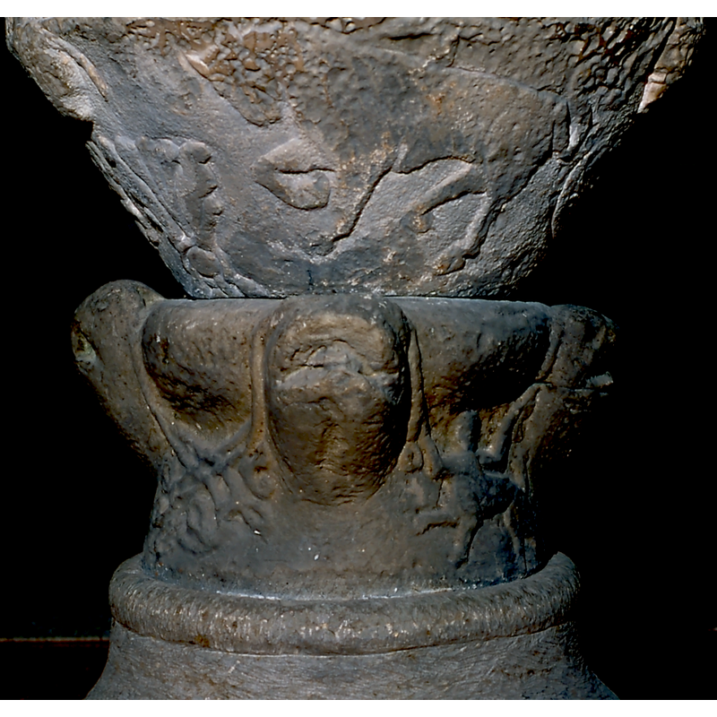 though much eroded now, it was probably rendered originally as an animal head -- on the southwest side of the base [orientation is approximate]