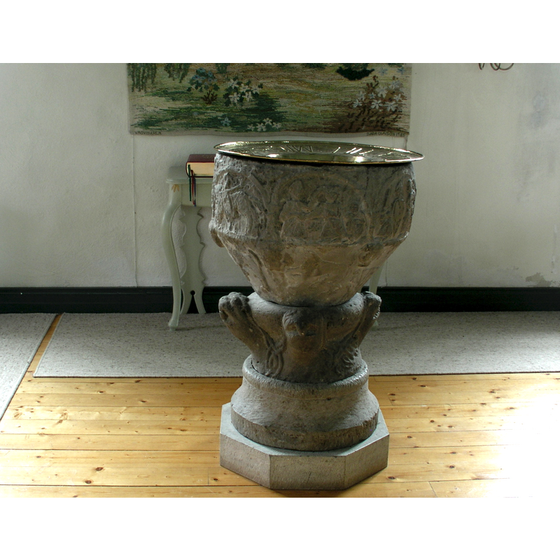 the reconstructed font with the brass baptismal dish on top
