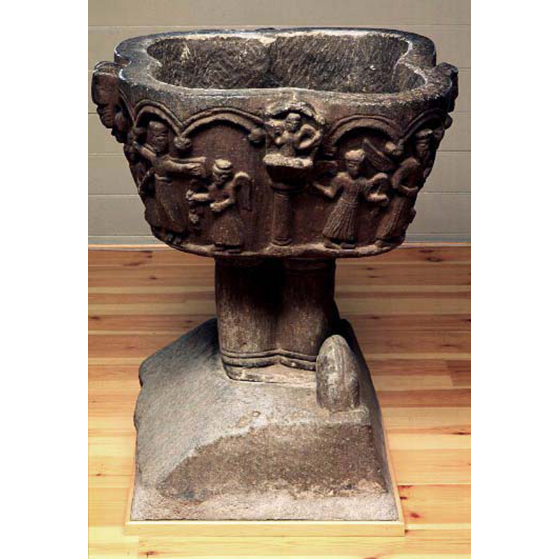 on the left side of the basin is part of the Crucifixion scene, with the turiferary angel by the right arm of the cross; the conceve centre has a column with a well-defined capital on which rests a demi-figure with arms akimbo; on the right is part of the scene of the weighing of the souls (?), a larger angel at the centre of the scene, a samller angel on the left
