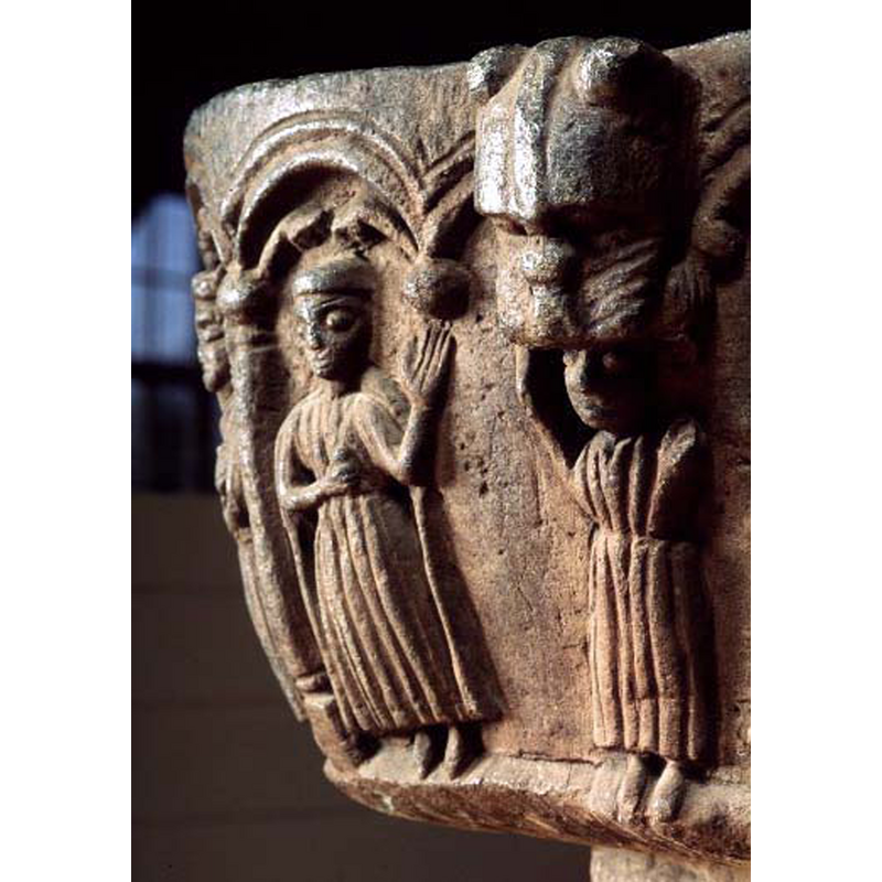 in one of the 'spandrels' or concave recesses of the quatrefoiled basin; the figure in orant is not being devoured by the lion above