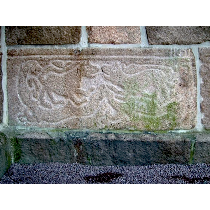 an earlier stone incorporated into the tower north wall of the 19th-century church here
