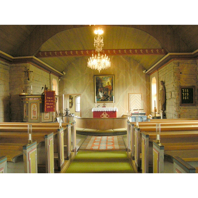 the top of the font is visible in the chancel, right [south] side, by the wooden statue of St. Michael on the left wall