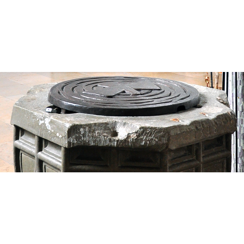 showing the damage to the upper rim, the date inscription on the right side, and the cover