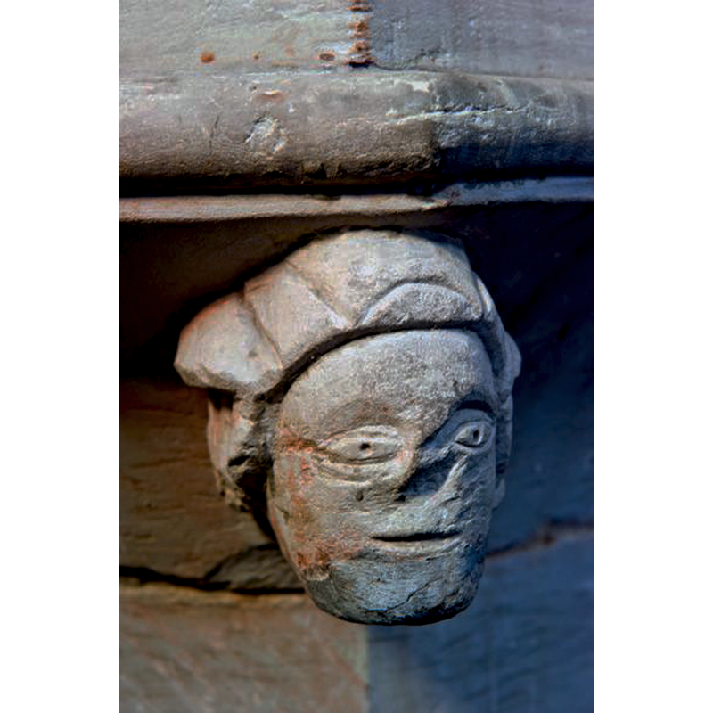 one of the heads at the angles of the underbowl