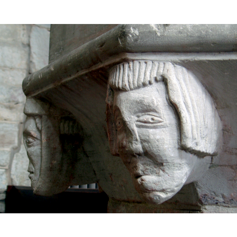 on the left is the woman wearing a wimple; on the right is a male head [is the deformity all caused by damage, or was some of it original?]