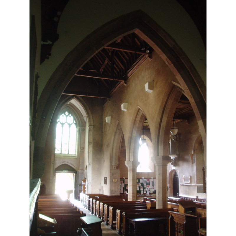 the modern font is sillouetted against the open west door