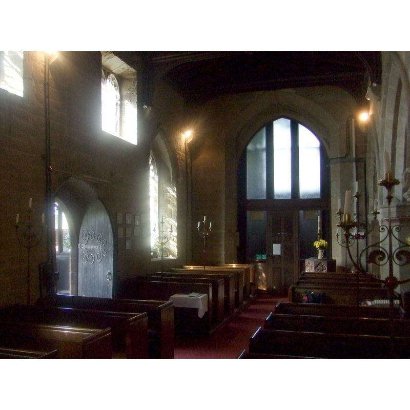 the modern font is partially visible at the far [west] end, right [north] side of the nave