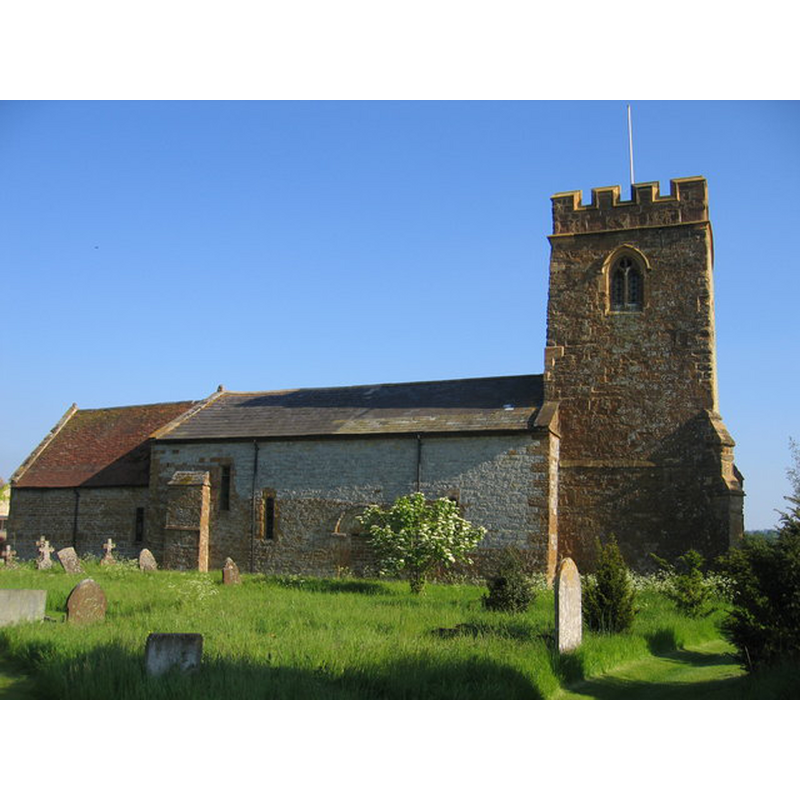 the blocked north portal, approximately in the middle of the nave volume, is partially covered by the tree in this image