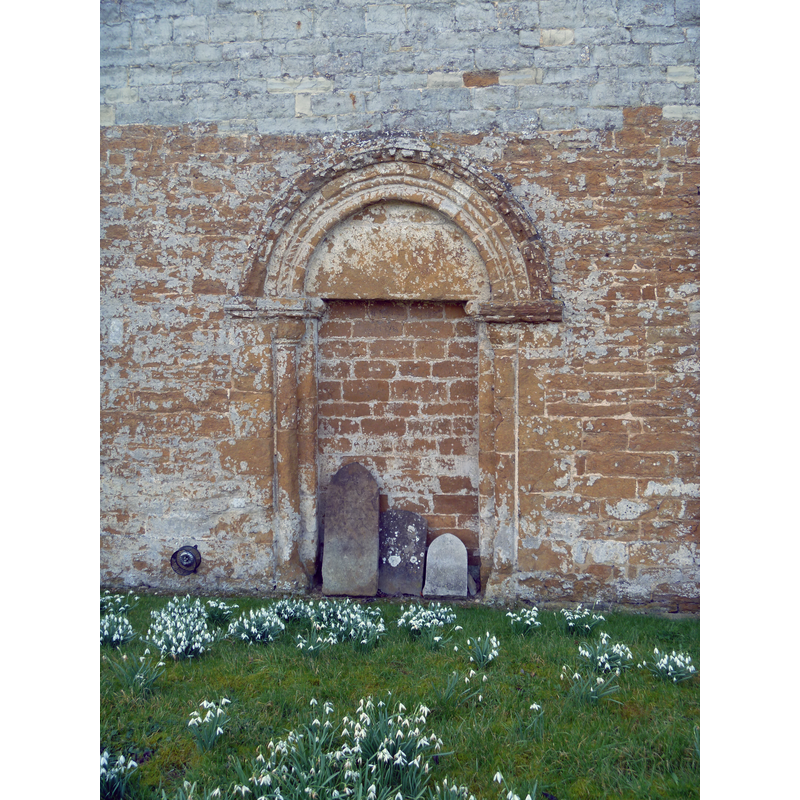 Source caption: "This blocked doorway is in the north wall of the church of St Peter." The VCH dates it to the mid-12thC [cf. FontNotes]