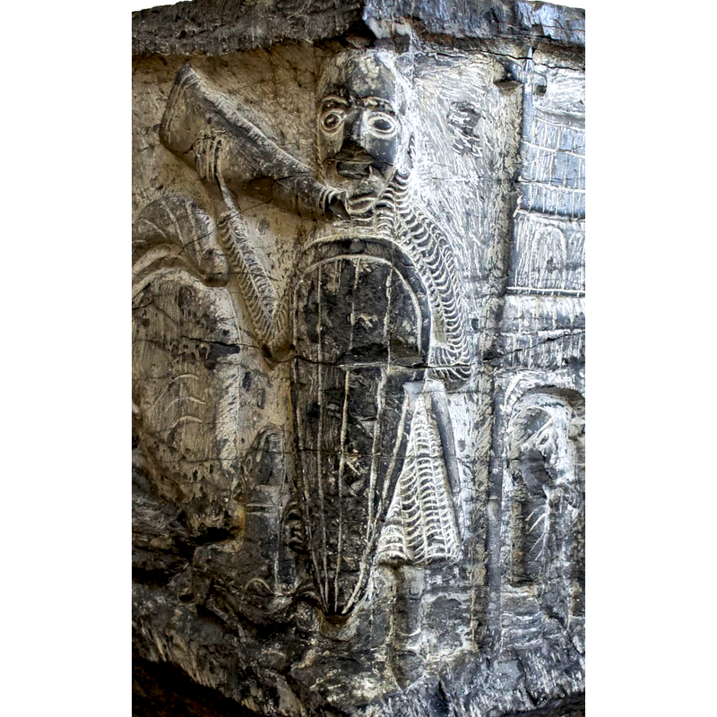 the warrior is blowing the horn towards the hunt/fight scene; long shield covers most of his front; dog at his feet -- on the southeast corner of the basin [NB: orientation is approximate]