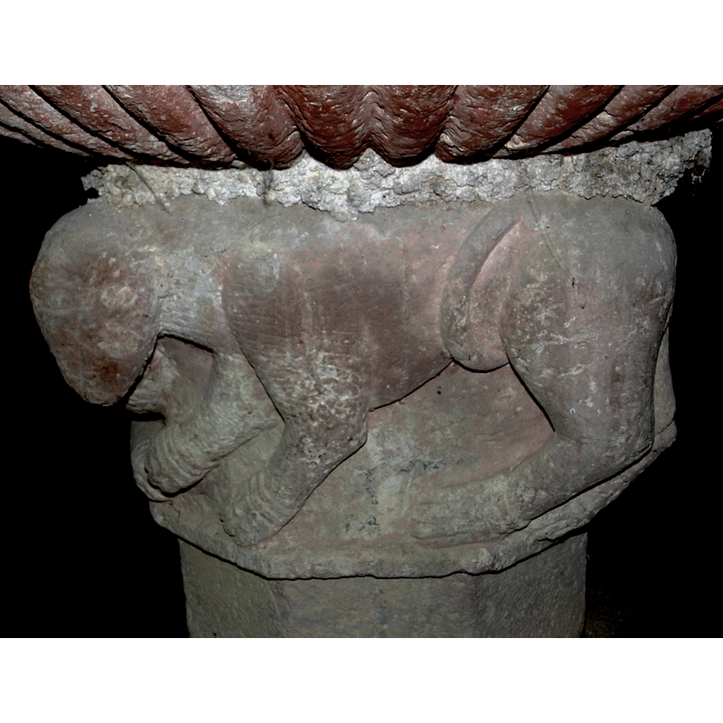 passant to the left -- on the east side of the font base [NB: orientation is approximate]