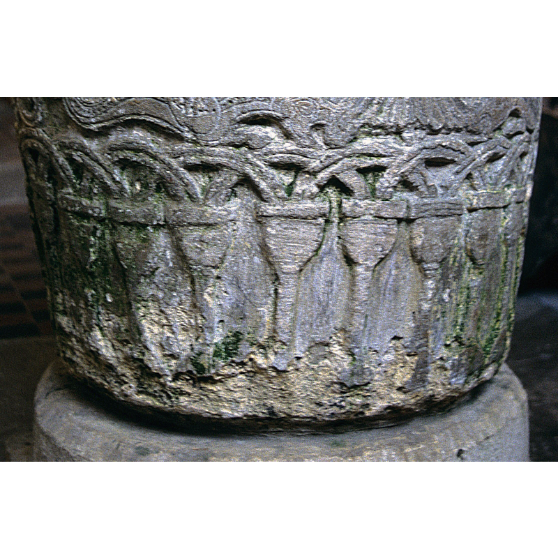 small round arches on tall heavy columns -- notice the deterioration of the stone in some areas
