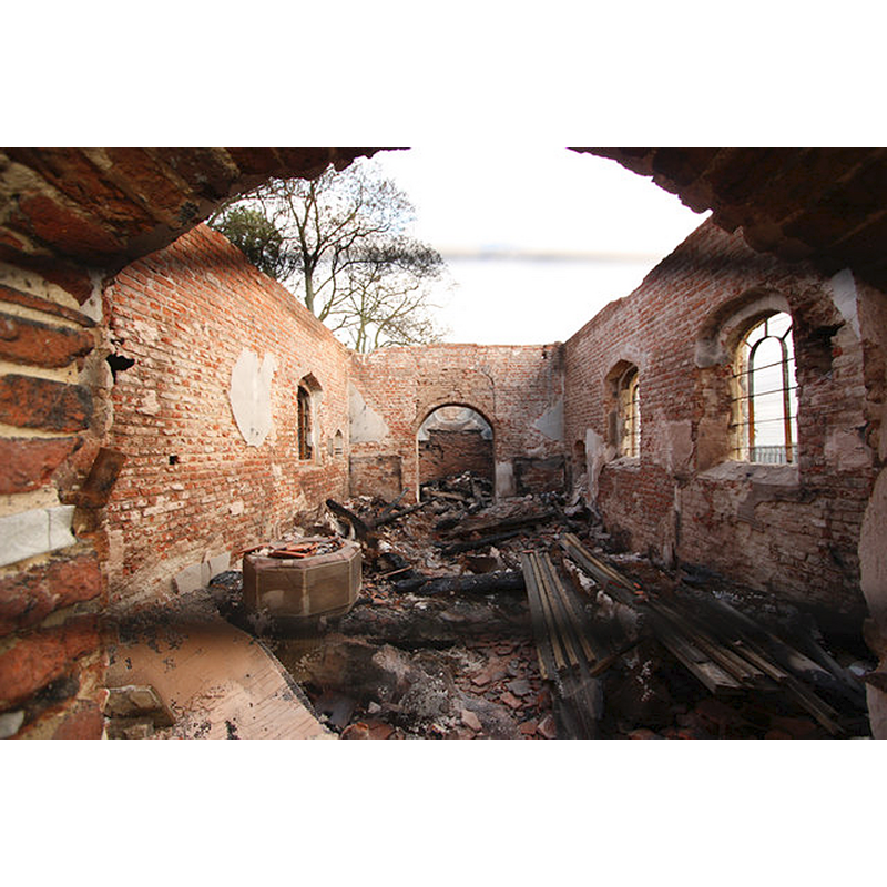 photograph taken five days after the 2013 fire -- Source caption: "St.George's church interior. Wide-angle view through security fencing to the burned out interior of St.George's church"