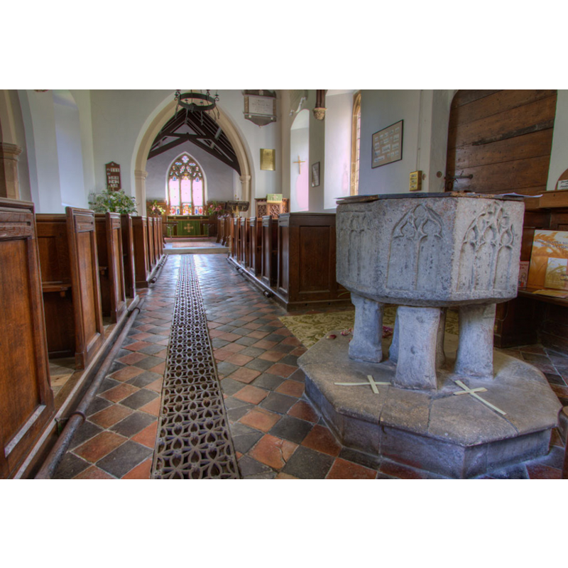 Source caption: "Font by the south porch entrance with its fine tracery on each panel"