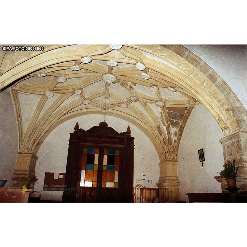 the font behind a railing, at the west end, north side of the nave