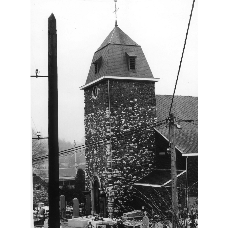 the fragments of the font are built into the tower wall; one is at the southwest angle, down from the clock, just west of the drain pipe