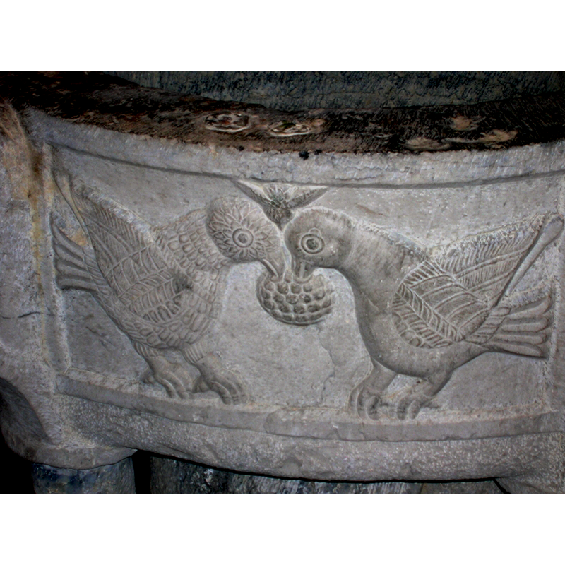 notice the detailed carving on the bird on the left; by contrast, only the wing and tail of the bird on the right are detailed -- notice also the plugged holes in the upper rim, anchorage points for an earlier font