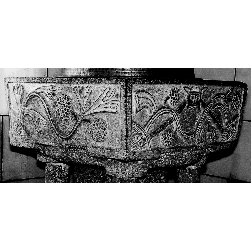 three of the basin sides have a grotesque hairy head at the bottom left corner with a vine stemming from it