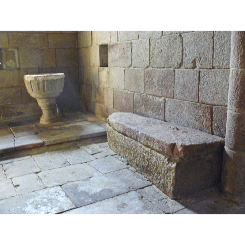 late font or stoup and old tomb inside the monastery church