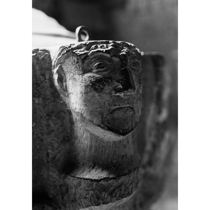 the top of the head is missing; the remaing metal staple of the cover is visible above it