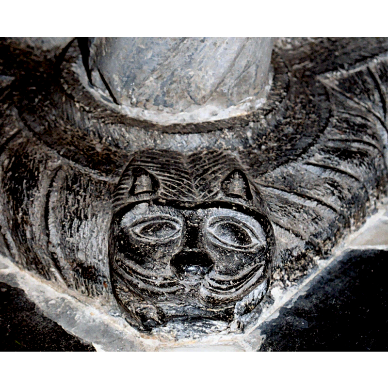 ornamentation on the lower base: one at each base of the outer columns, plus one at each side between the columns