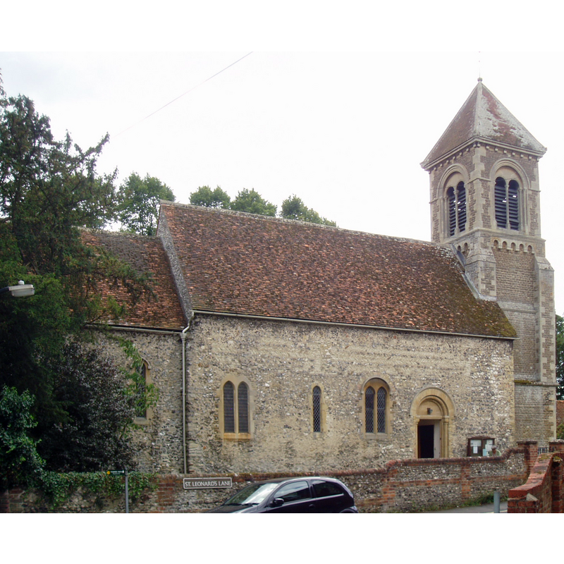 Source caption: "St Leonard's in Wallingford is a real surprise, it's tower is such a blatant piece of Victoriana one would never suspect that beneath it lies a genuine 12th century Romanesque church with excellent period details. The north side of the nave, chancel and apse are more apparently Norman work with herringbone masonry in places. The opposite side of the nave and south aisle are all Victorian work of the heavy 1849 restoration by Henry Hakewill, along with the tower (the church previously had no tower). The church had suffered heavily during the civil War and was for a time left in ruins. The interior reveals the finest Norman survivals in the chancel and apse arches, decorated with intricate carving (with faces on the apse capitals). The 'Norman' arches in the nave arcade by contrast are all fanciful Victorian work, making an interesting comparison with the genuine Romanesque nearby. The most notable fittings are the apse windows by Sir Ninian Comper and mural panels of angels by G.D.Leslie from 1889. The font is plain but has an eye-catching flat brass cover. The church is normally kept locked outside of services."