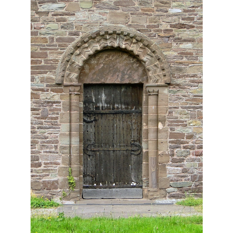 Source caption: "Norman doorway, Peterchurch. On the North side of this outstanding church is this 12th century doorway, complete with original door and ironwork."