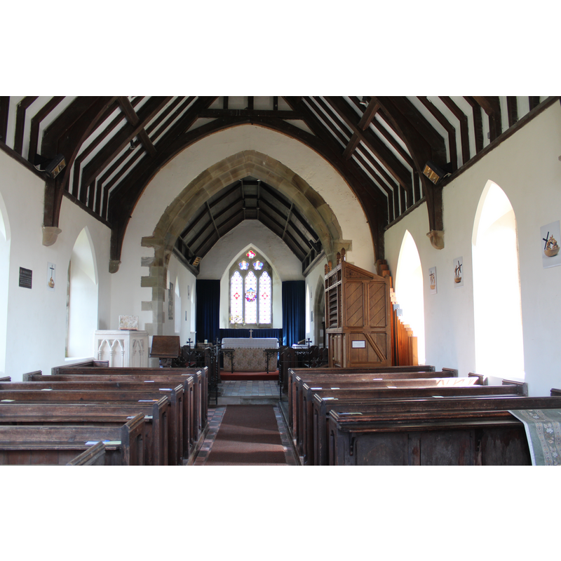 Source caption: "Interior of St Mary's church, Tretire. The church was rebuilt in 1856 on the site of the medieval church. The pine harmonium was made by Dale, Forty & Co around the beginning of the 20th century. The east window depicts The Last Supper."