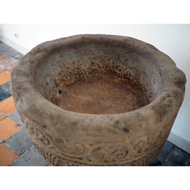 there is a small drain hole visible on the left side of the bottom of the inner well; it was probably done when the font was used as water-trough in a garden