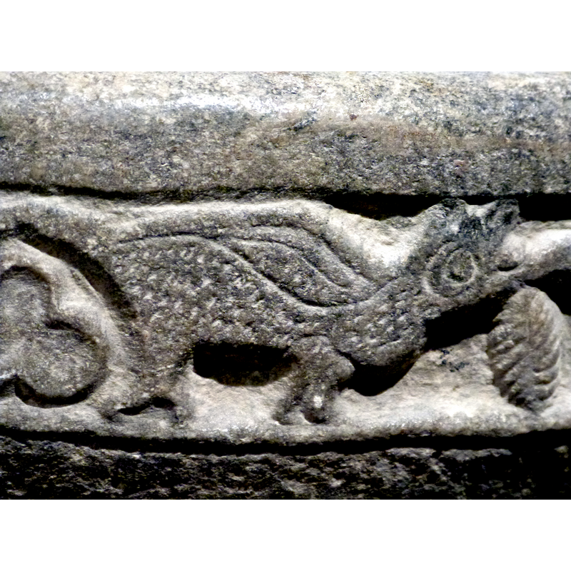 the tail ondulates all around the basin side to end in its mouth; the tail is also a vine