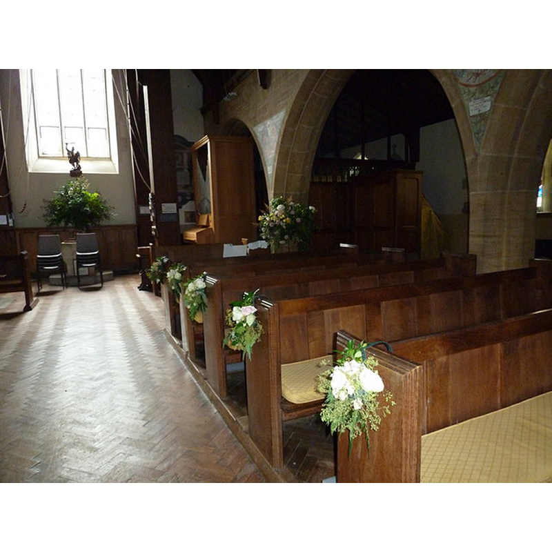 the font is partially visible at the far [west] end, behind the two chairs