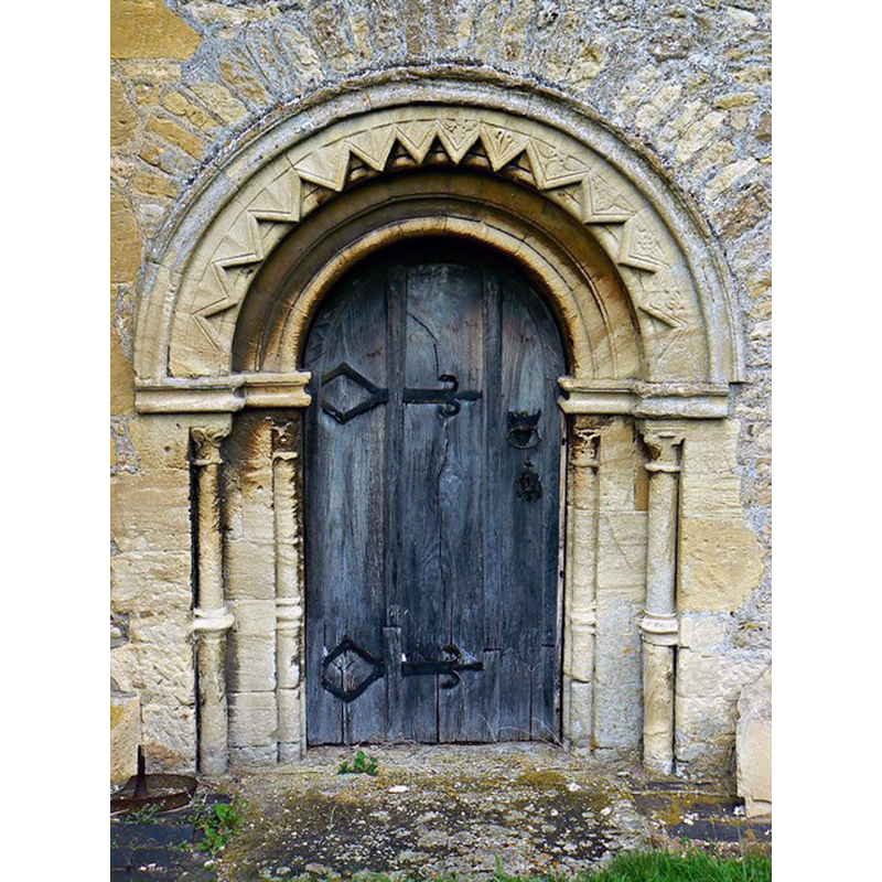 Source caption: "Chancel door [...] The doorway is part of the original 12th century church and is typical of that period. Inside it is covered by a curtain."