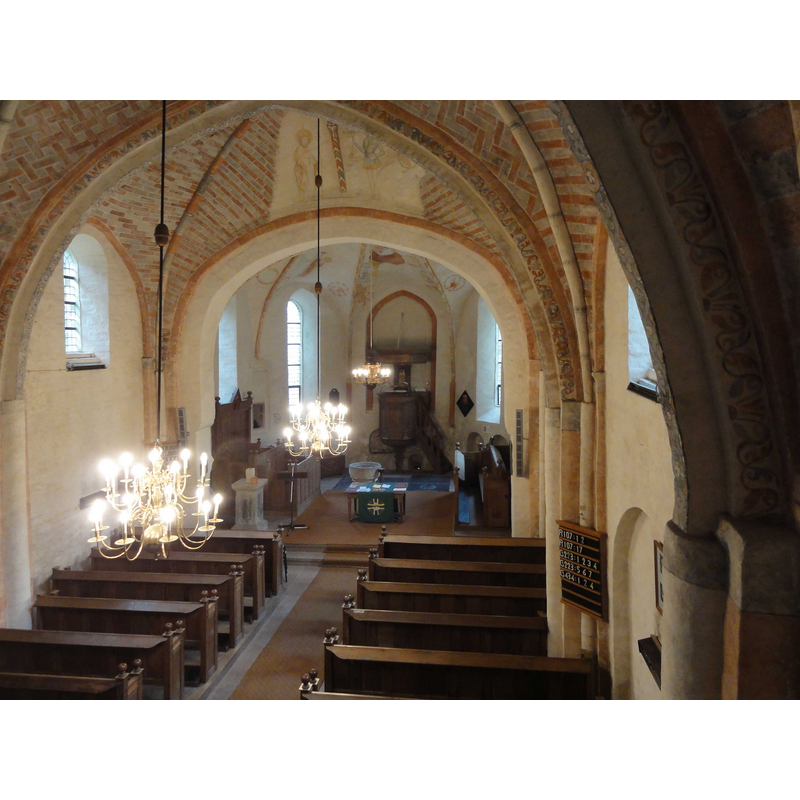 the old font, originally from Toorword, is visible here in the chancel, behind the altar, to the left [north]