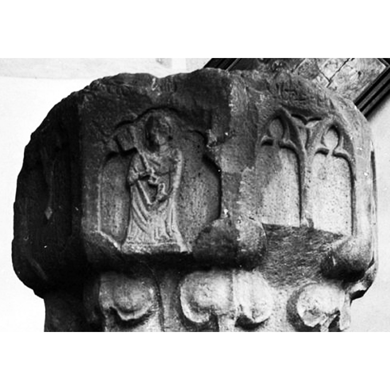 in the spandrel between the two arches/windows