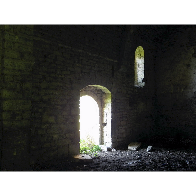 the flat stone by the left [east] side of the doorway could be the plinth of the old font