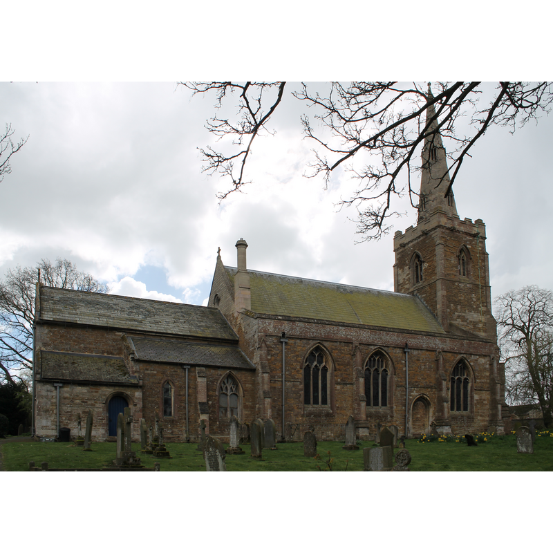 Source caption: "Although the church is medieval it is entered through a 15th C porch, with the door to the church itself being of 13th C, built in the Early English style. Just inside the entrance to the church is the font which dates from the 14th C which is octagonal and carved to show different styles of window tracery – Geometric, Decorated and Perpendicular. The base has a hollow stem and through the ornamental carving can be seen a three-headed monster in chains, perhaps suggestive of the restraint put upon evil through the power of baptism."