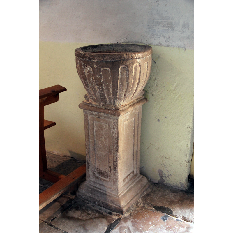 probably a composite object; located inside the doorway, against the south wall of the nave
