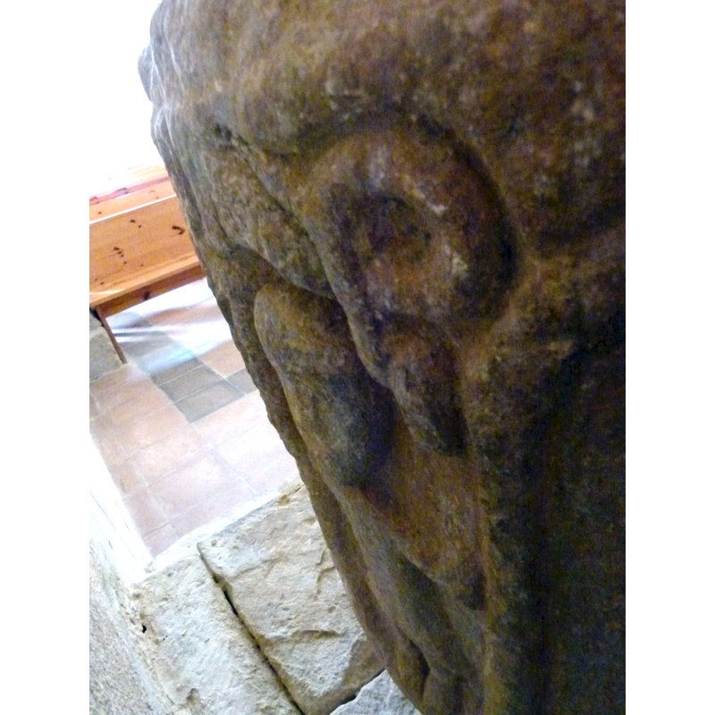 the right side above the human figure shows the coil of the snake's body; what is not clear is whether the end to the right is the snake's head or part of the man's hand or arm, which is broken off below