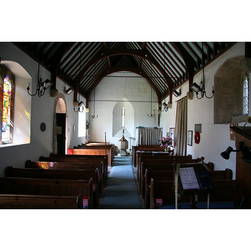 Source caption: "St.Mary's nave. Looking west with a tiny, deeply splayed 13th century lancet west window."
