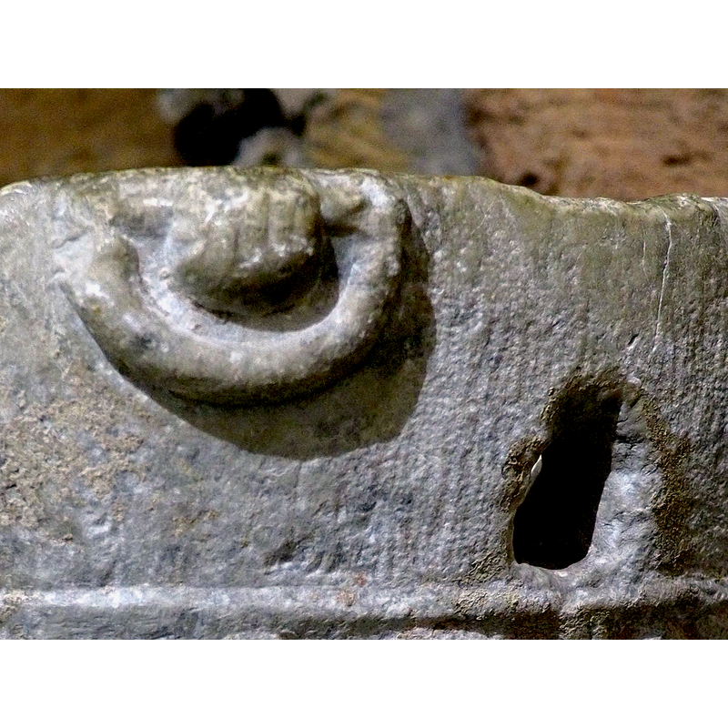 the upper part of the motif may be missing, since the upper rim of the basin is very worn; a fist around a handle