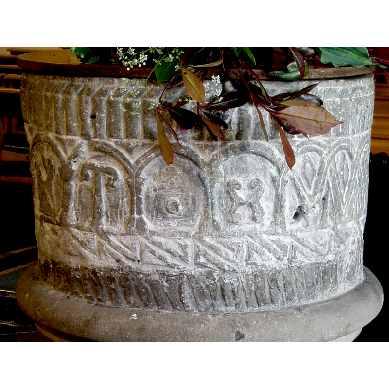 each with a symbol or motif in it -- in one section of the arcade some of the arches cross others and form a sort of interlace, some of the spaces with lozenges in them